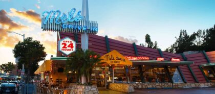 Exterior of Mel's Drive-In in West Hollywood, with its neon sign lit up at night