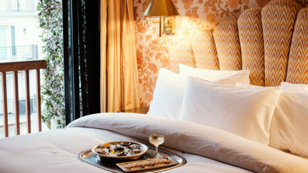 Room at the Petit Ermitage in West Hollywood. Pictured is a bed and wall with decorative wallpaper.