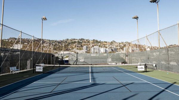 Rooftop tennis court at Le Parc at Melrose hotel, with the Hollywood Hills in the background. West Hollywood, California.