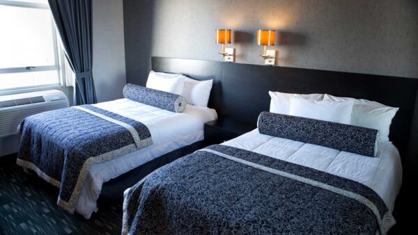 Double room at the Ramada Plaza Hotel & Suites West Hollywood, featuring a gray palette.