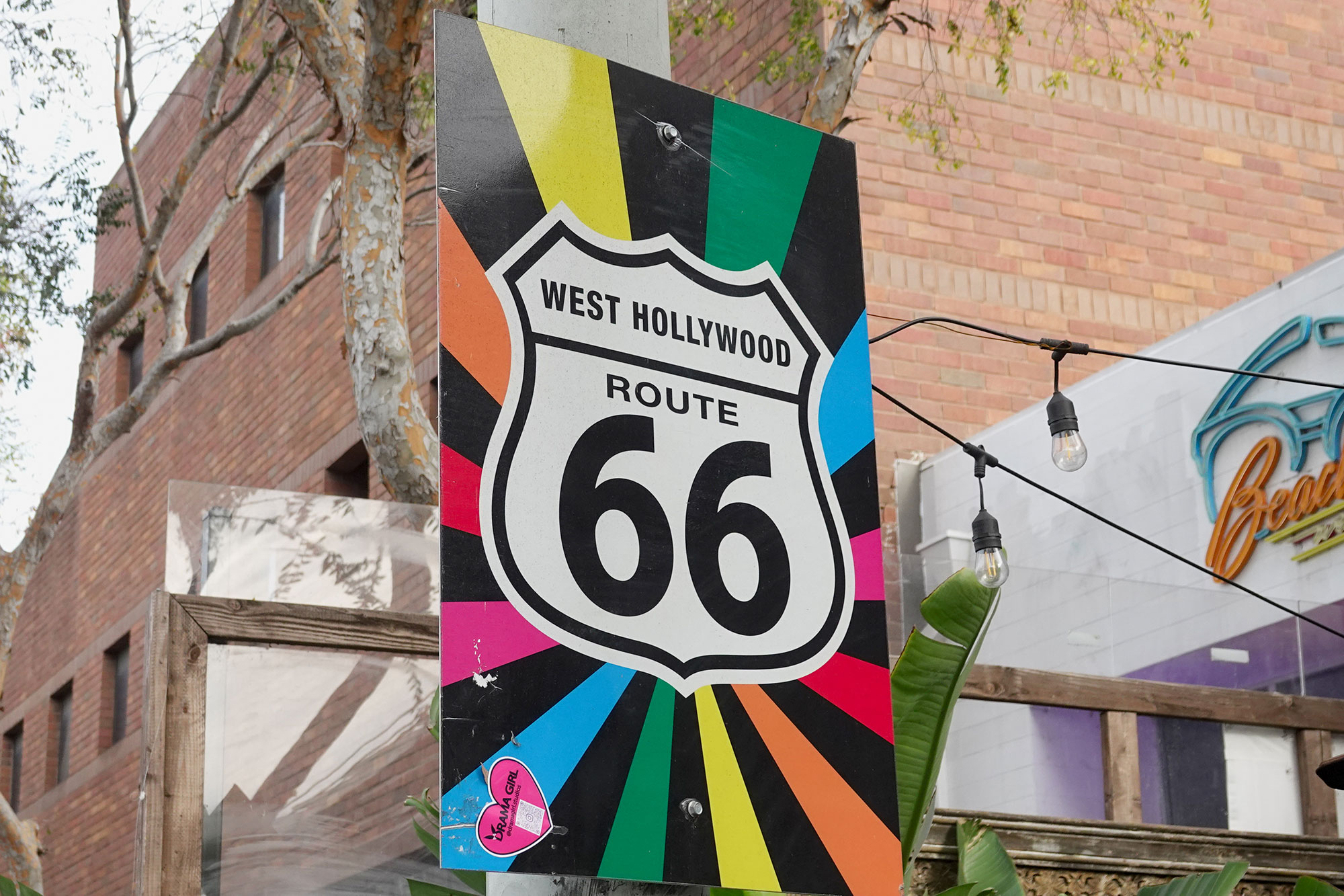 A Route 66 marker with rainbow colors in West Hollywood's Rainbow District