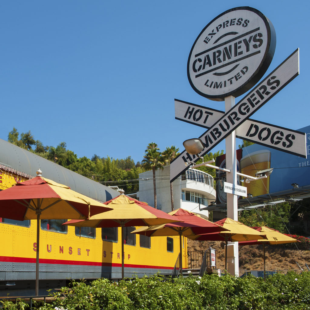 Exterior of Carneys, a restaurant located in a yellow train car.