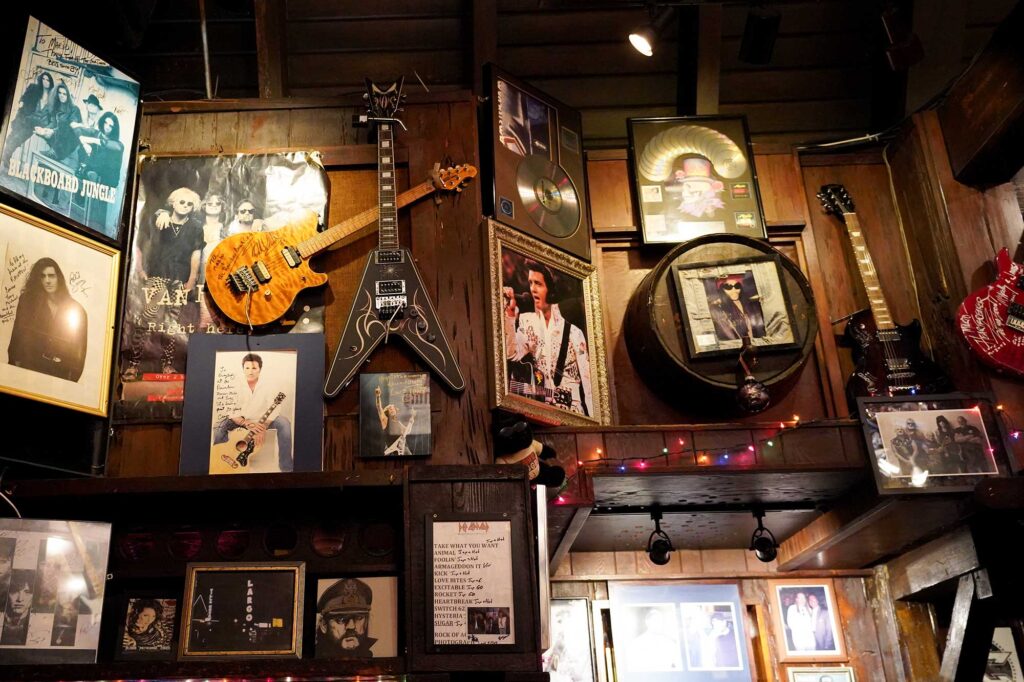 A wall is covered with music memorabilia at Rainbow Bar & Grill in West Hollywood