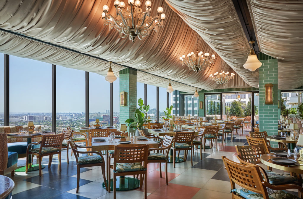 Interior of Merois, with fabric-draped ceilings, dramatic chandeliers, and views of LA out of floor-to-ceiling windows. West Hollywood, CA.