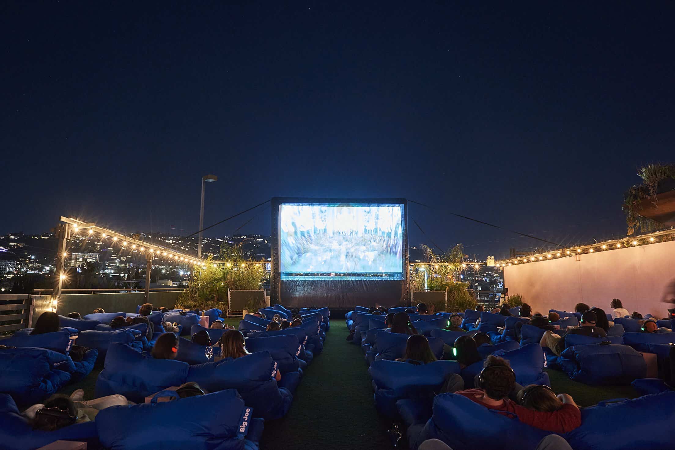 People watch a movie under the stars at Melrose Rooftop Theatre.