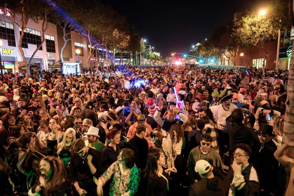 A crowd of costumed revelers gathers on Santa Monica Boulevard during the annual West Hollywood Halloween Carnaval.