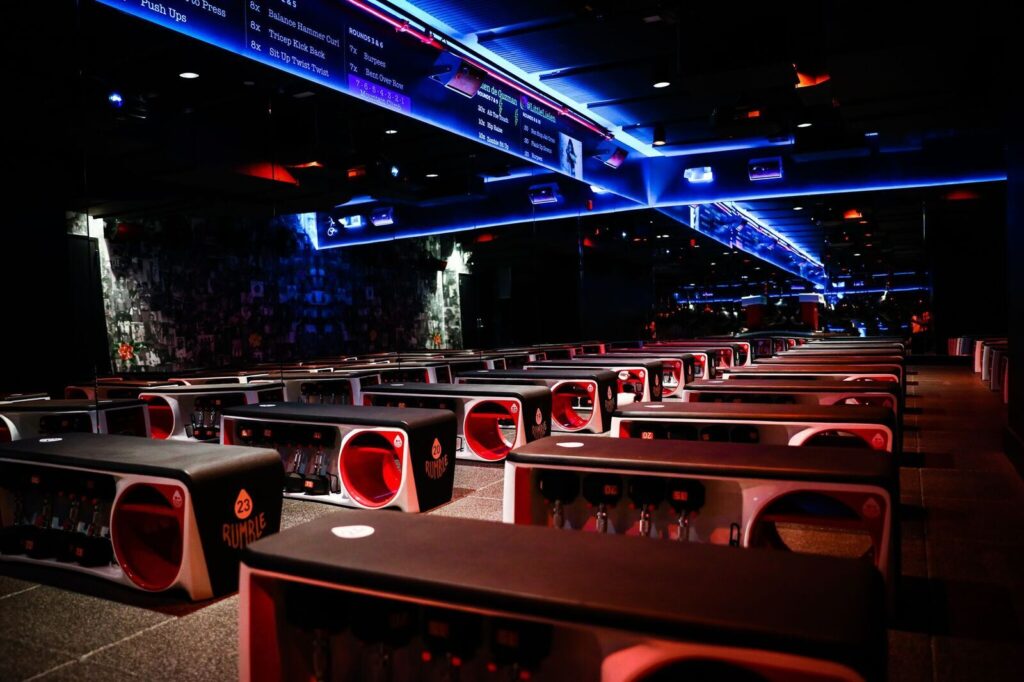 The interior of Rumble Boxing in West Hollywood that is dimly lit with LED lights.