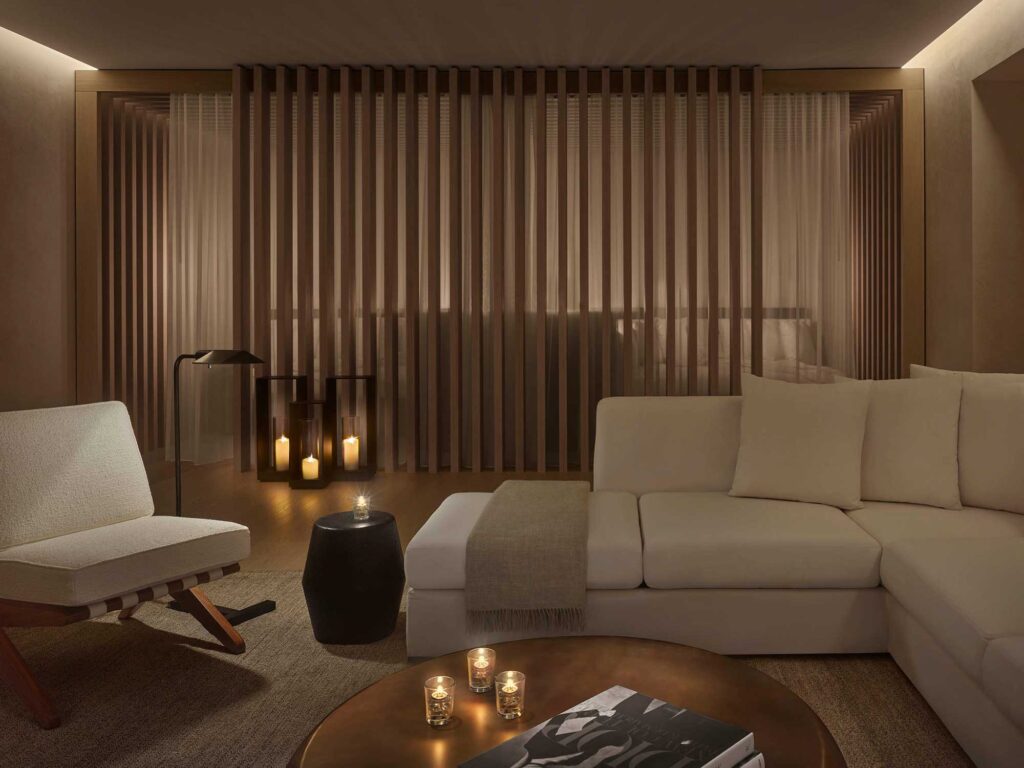 Relaxation room at The Spa at The West Hollywood Edition, with white sofas, minimalist chairs and soft lanterns.