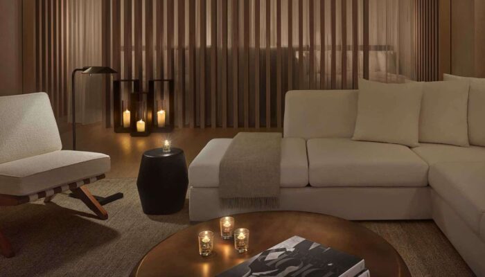 Relaxation room at The Spa at The West Hollywood Edition, with white sofas, minimalist chairs and soft lanterns.