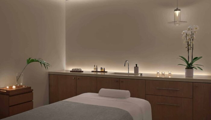 The exterior of Farm Cup Coffee features a glass garage door holding a yellow vintage food truck.