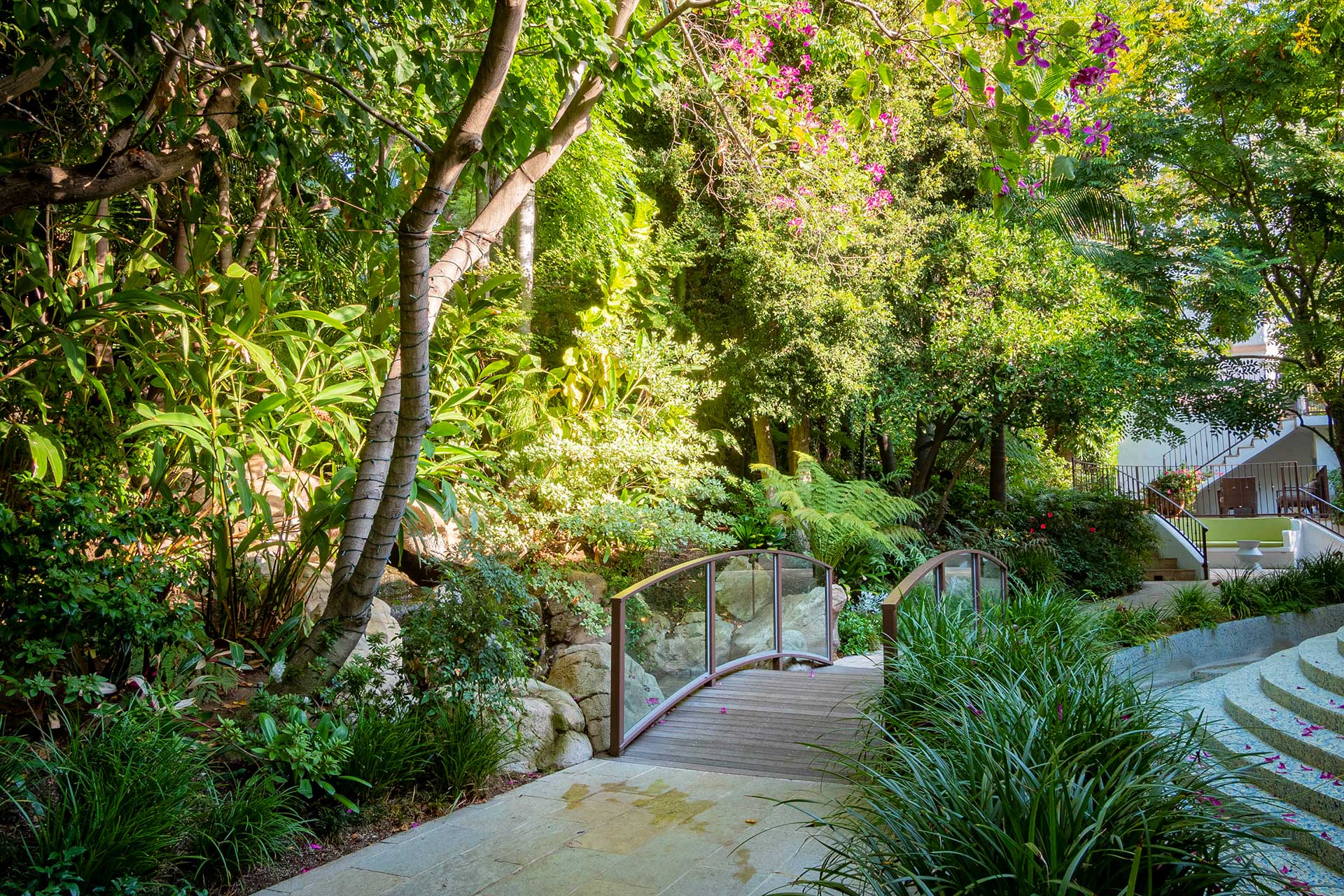 Blooming flowers and thick foliage at the oasis-like grounds of the Sunset Marquis Hotel. West Hollywood, California.