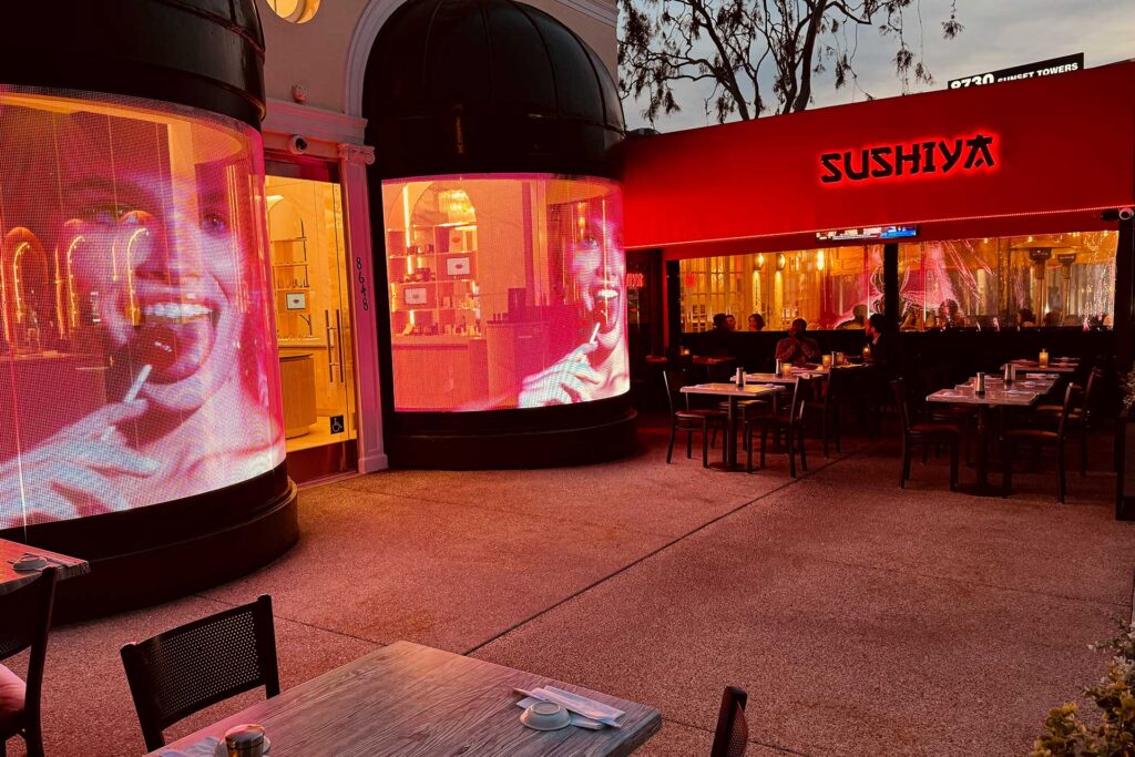 Exterior of Sushiya on Sunset features LED screens featuring a women's face. West Hollywood, California