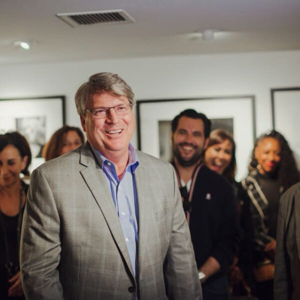 Rod Gruendyke, general manager of the Sunset Marquis Hotel, is pictured surrounded by a group of people.