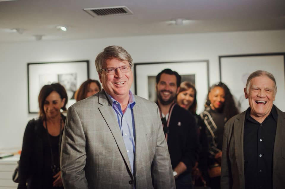 Rod Gruendyke, general manager of the Sunset Marquis Hotel, is pictured surrounded by a group of people.