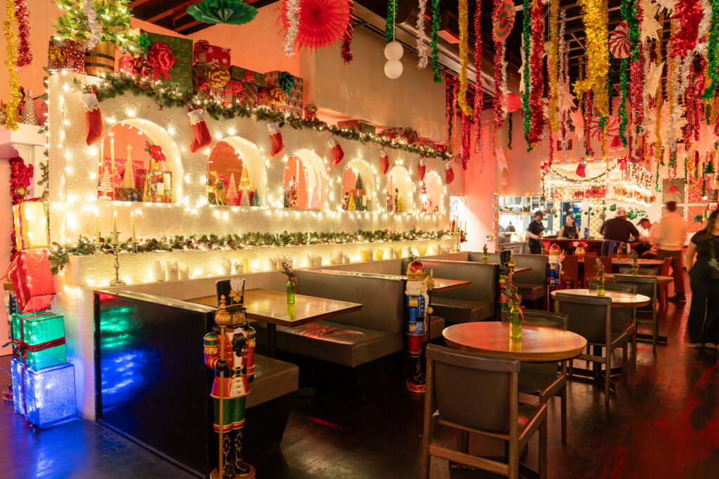 A restaurant is decorated in over-the-top holiday lights and decorations. Bombo at E.P. & L.P., West Hollywood, California.