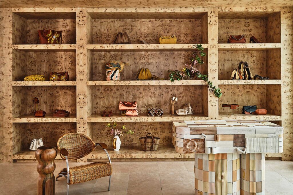 A wallpapered wall of shelves displays accessories at Ulla Johnson LA. West Hollywood, California.