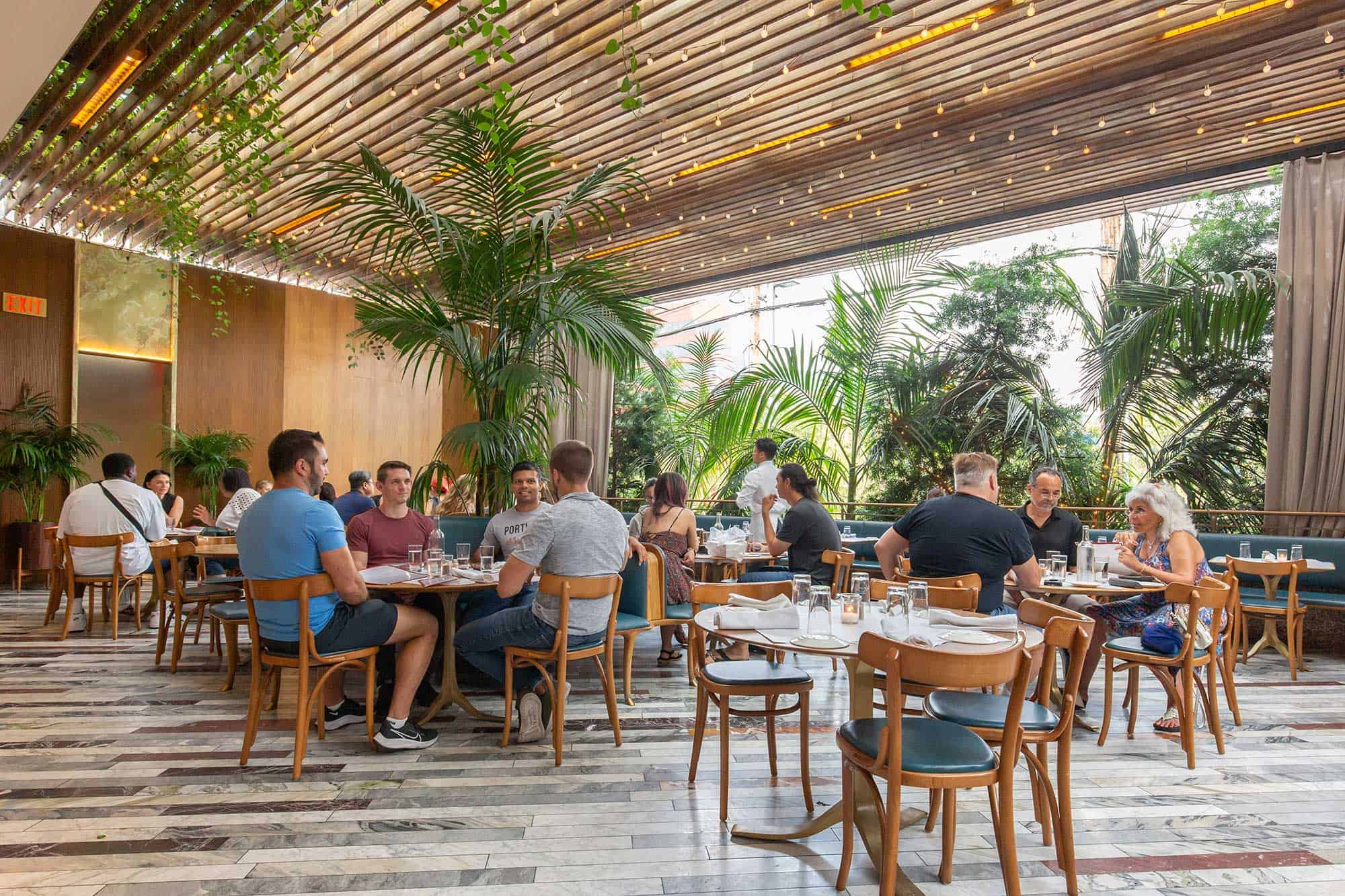 Diners sit on an open-air patio at Bottega Louie in West Hollywood