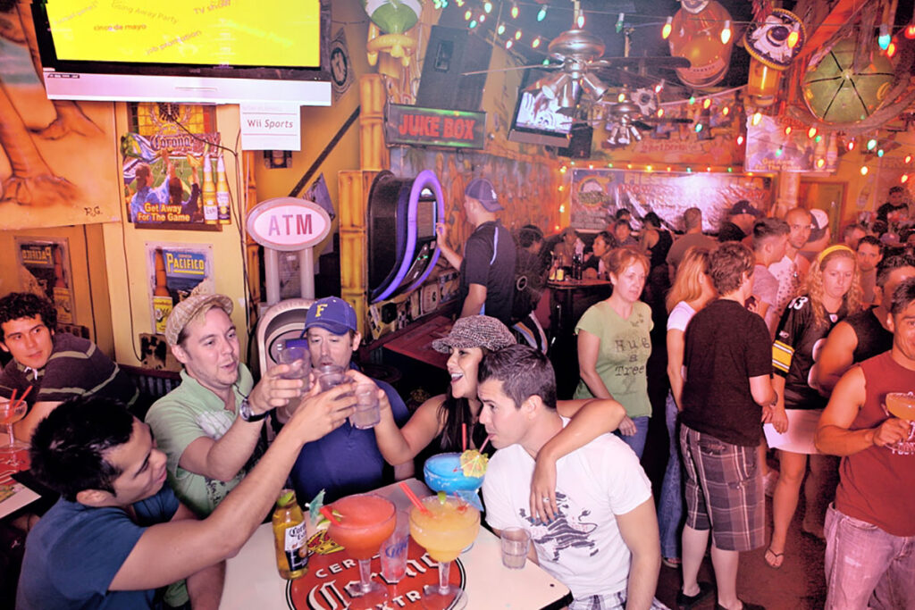 A group of people gather inside the festive dining room of Fiesta Cantina in West Hollywood, CA.