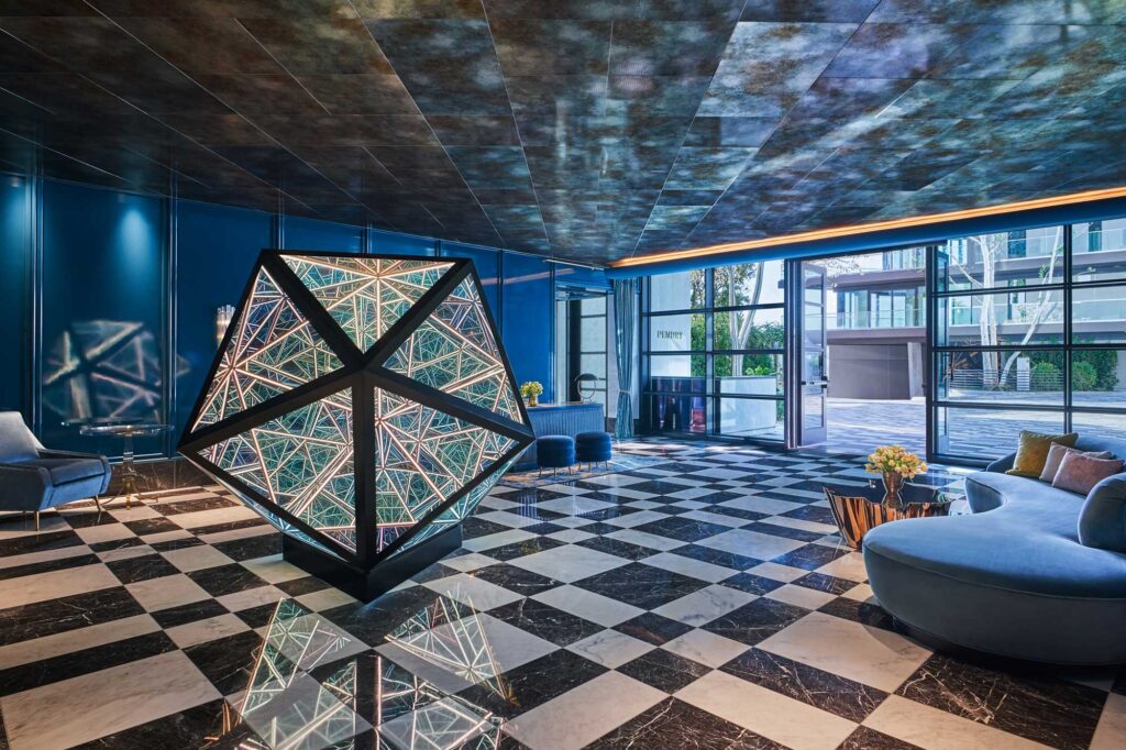 The lobby of the Pendry West Hollywood, with black-and-white checkered floors, geometric-style furniture and a stunning marbled ceiling.