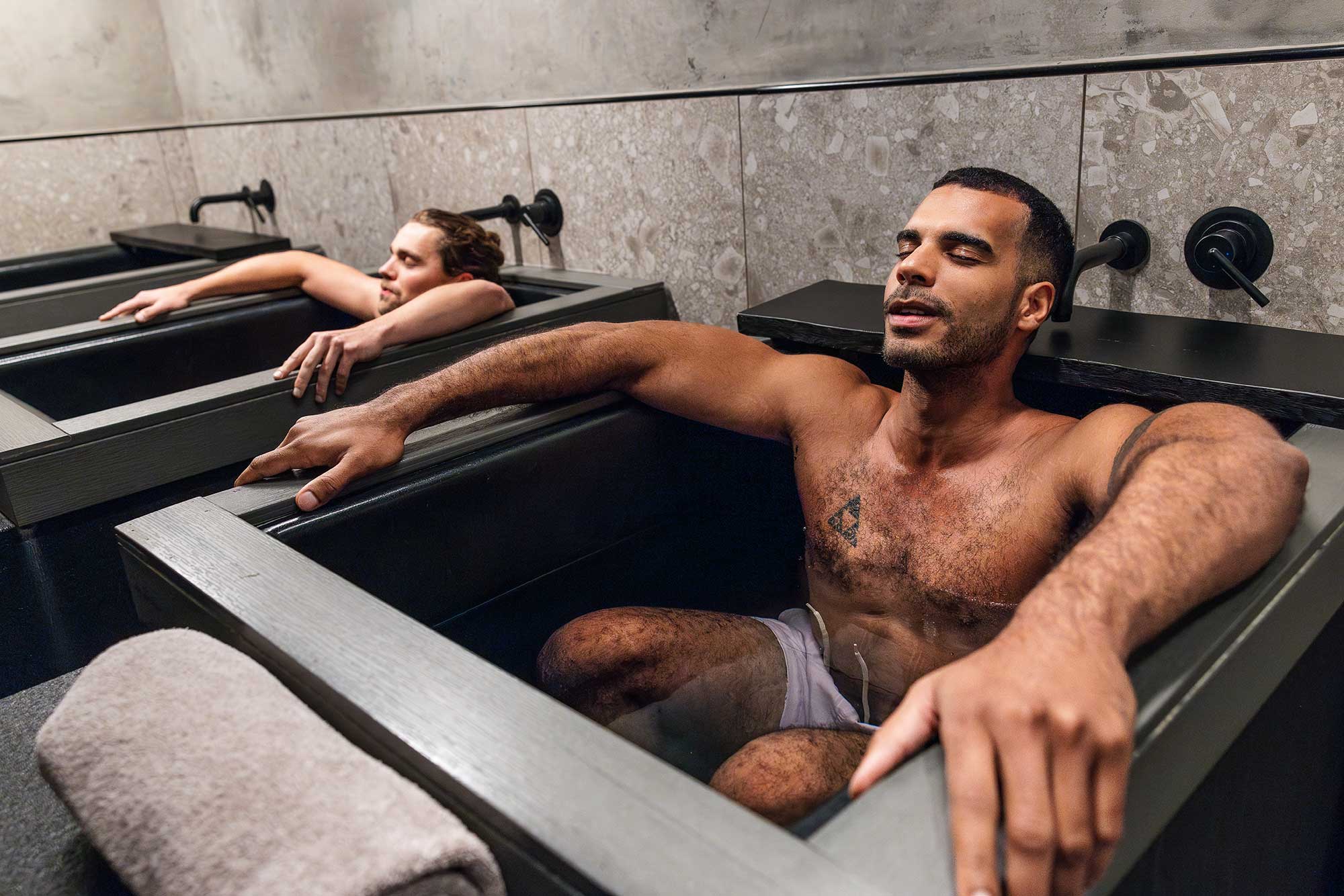 Two men sit in ice baths at Remedy Place in West Hollywood, California.