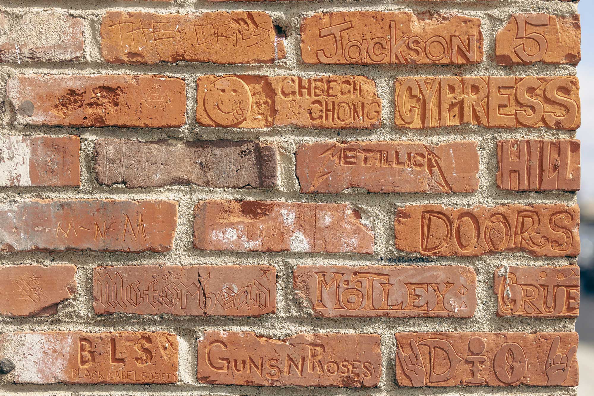 Close-up of bricks with etched names of musicians in West Hollywood. Rainbow Bar & Grill, West Hollywood, CA.