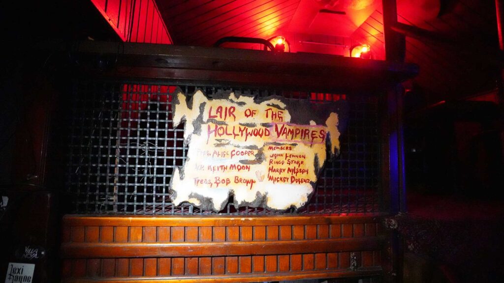 A sign at the Rainbow Bar & Grill says "Lair of the Hollywood Vampires," with a list of names including Alice Cooper, Keith Moon, John Linen, Ringo Starr, Harry Nilsson and Mickey Dolenz. West Hollywood, California.