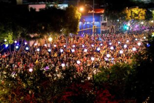 A large crowd of costumed revelers gathers on Santa Monica Boulevard for the West Hollywood Halloween Carnaval.