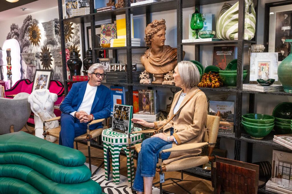 A man and a woman sit in designer chairs at Martyn Lawrence Bullard Atelier in West Hollywood, California.