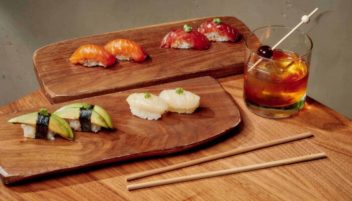 Chef Charbel Hayek serves food to a couple at Ladyhawk restaurant