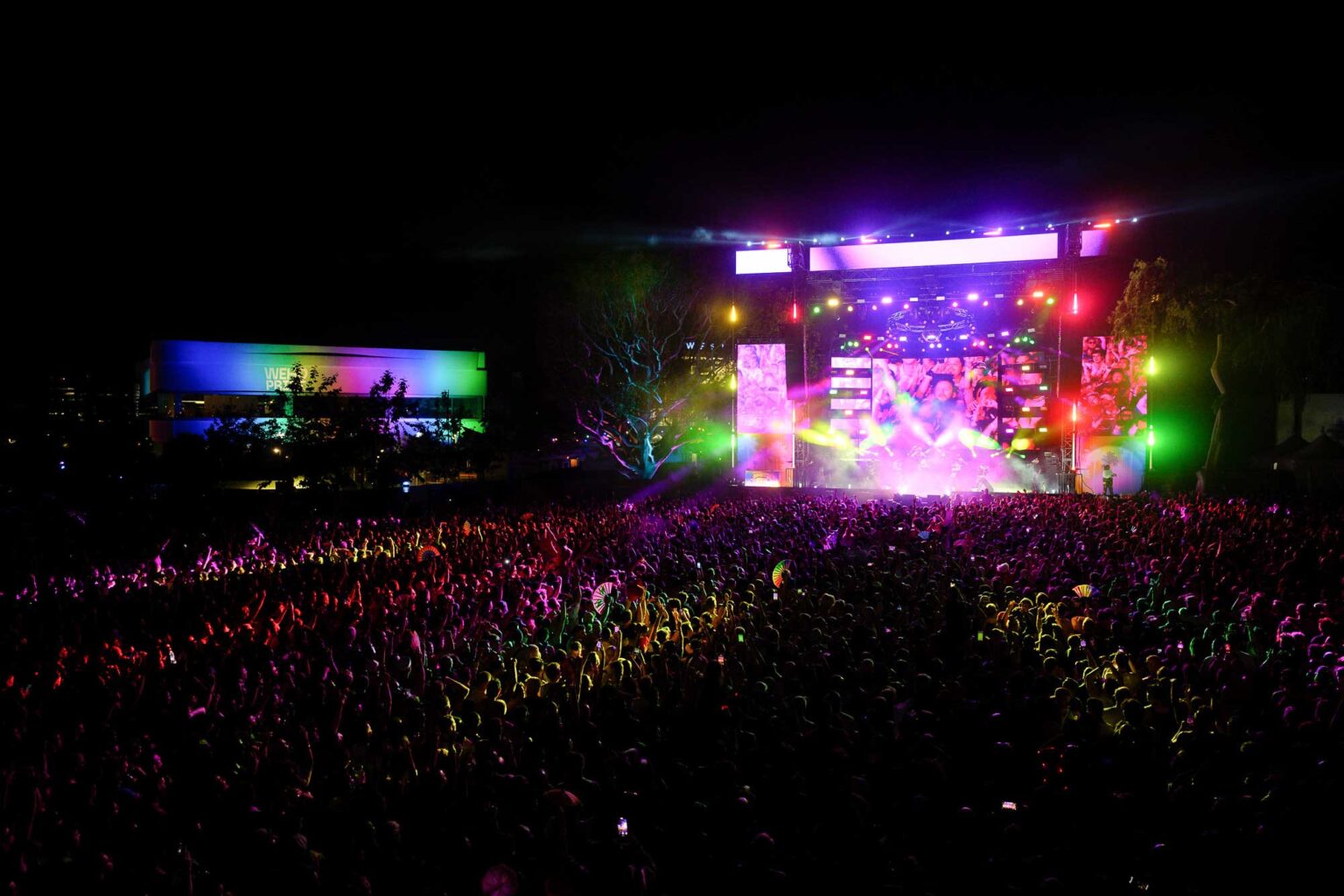 A large crowd watches a concert during the OUTLOUD music festival at WeHo Pride.