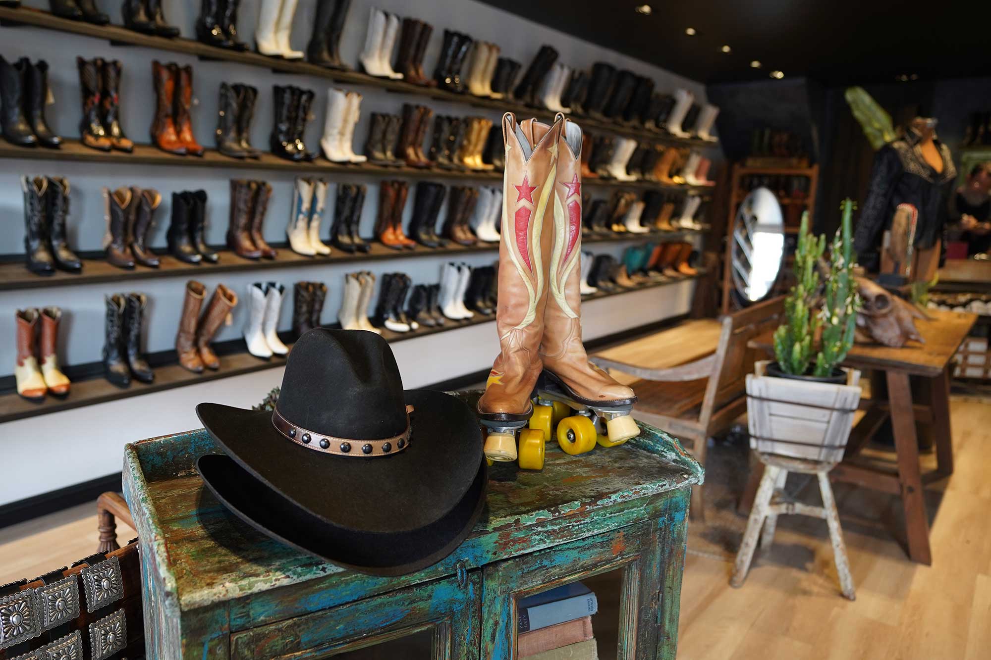 A retail display at Boot Star on the Sunset Strip featuring a black cowboy hat and a pair of cowboy boot roller skates. West Hollywood, California.