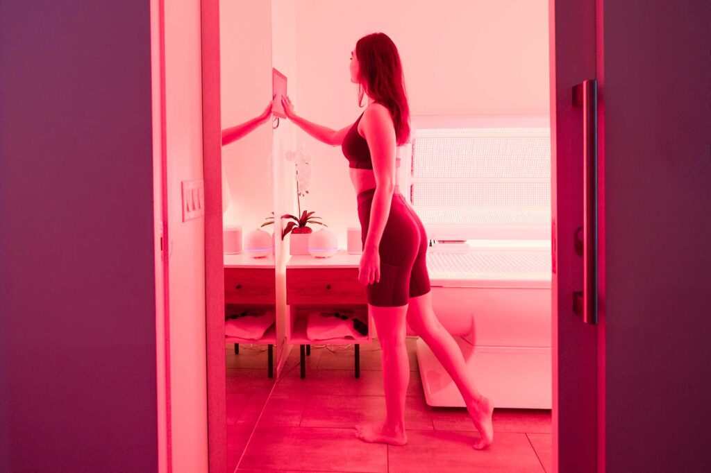 A woman adjusts a setting in a light-therapy lounge at Next Health in West Hollywood, California.