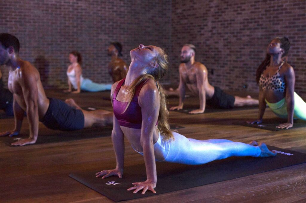 People hold a pose during a class at Sweat Yoga in West Hollywood, California.