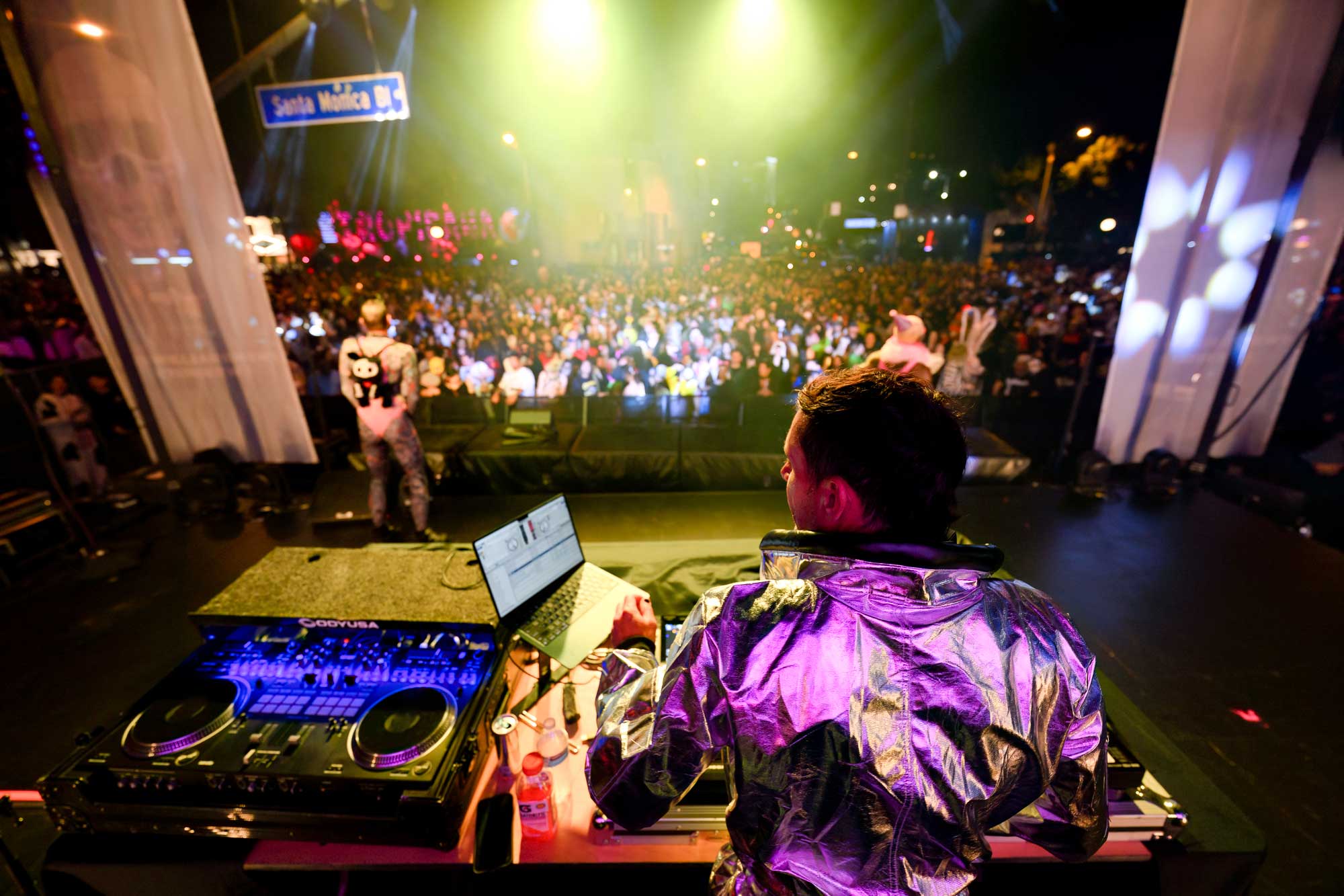 A DJ plays music for a large crowd at the West Hollywood Halloween Carnaval.