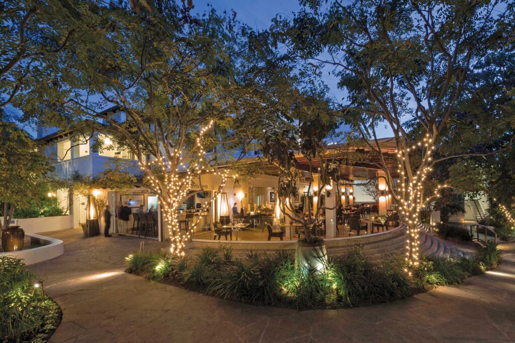 White fairy lights decorate the outdoor dining area at Cavatina, located at the Sunset Marquis hotel.