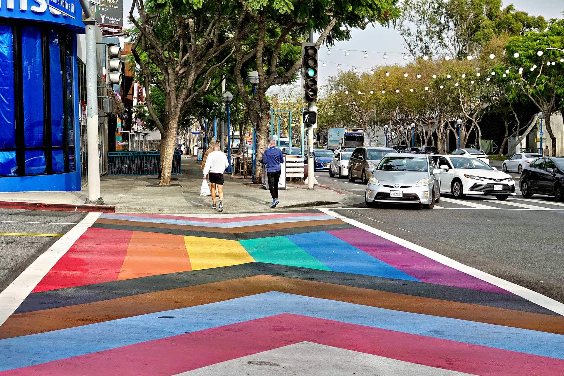 People walk on the Inclusive Pride Crosswalks in West Hollywood's Rainbow District