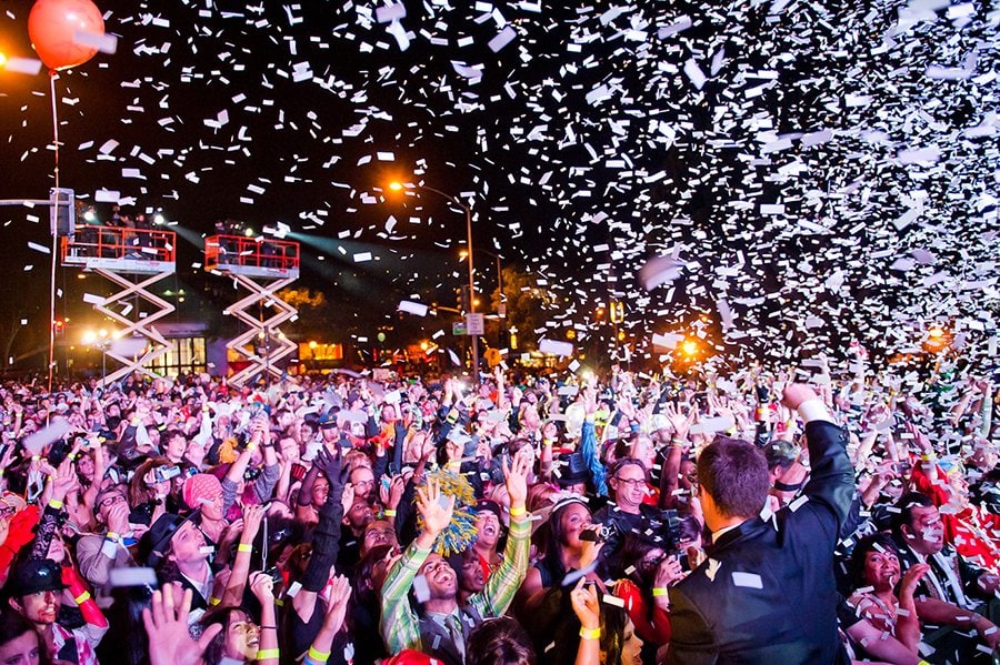 Confetti falls on a crowd of revelers at the West Hollywood Halloween Carnaval