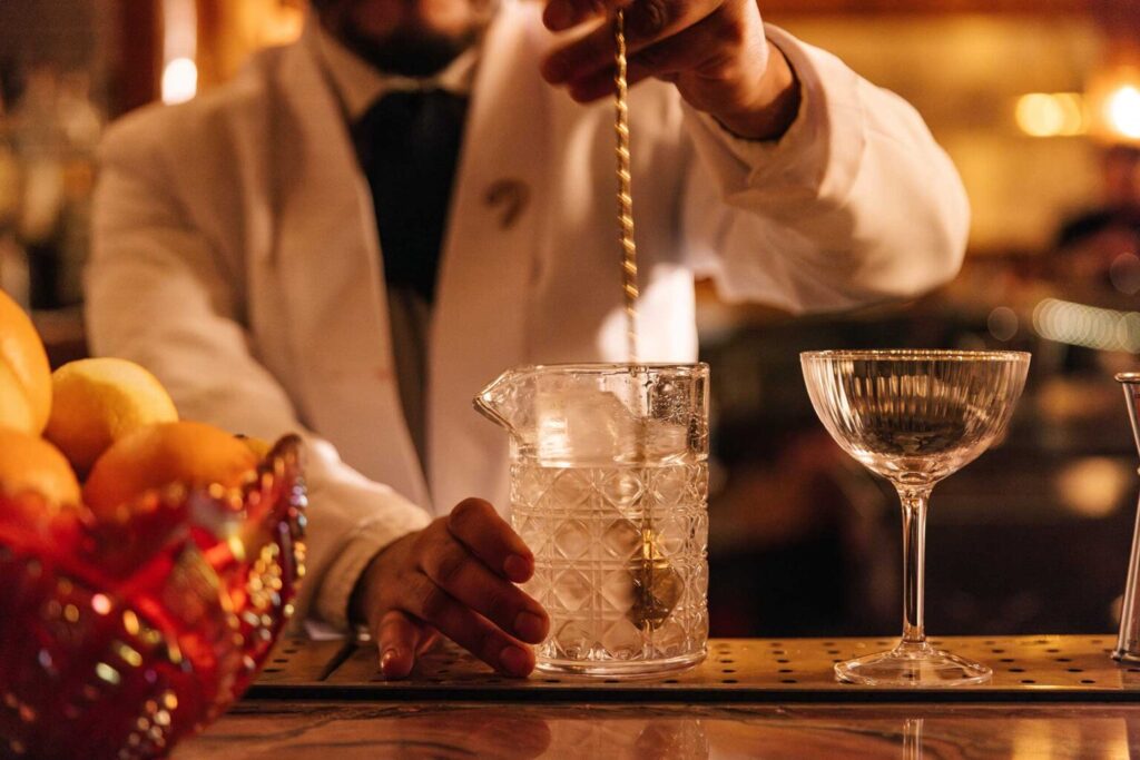 A bartender's hands stir a cocktail at Delilah in West Hollywood