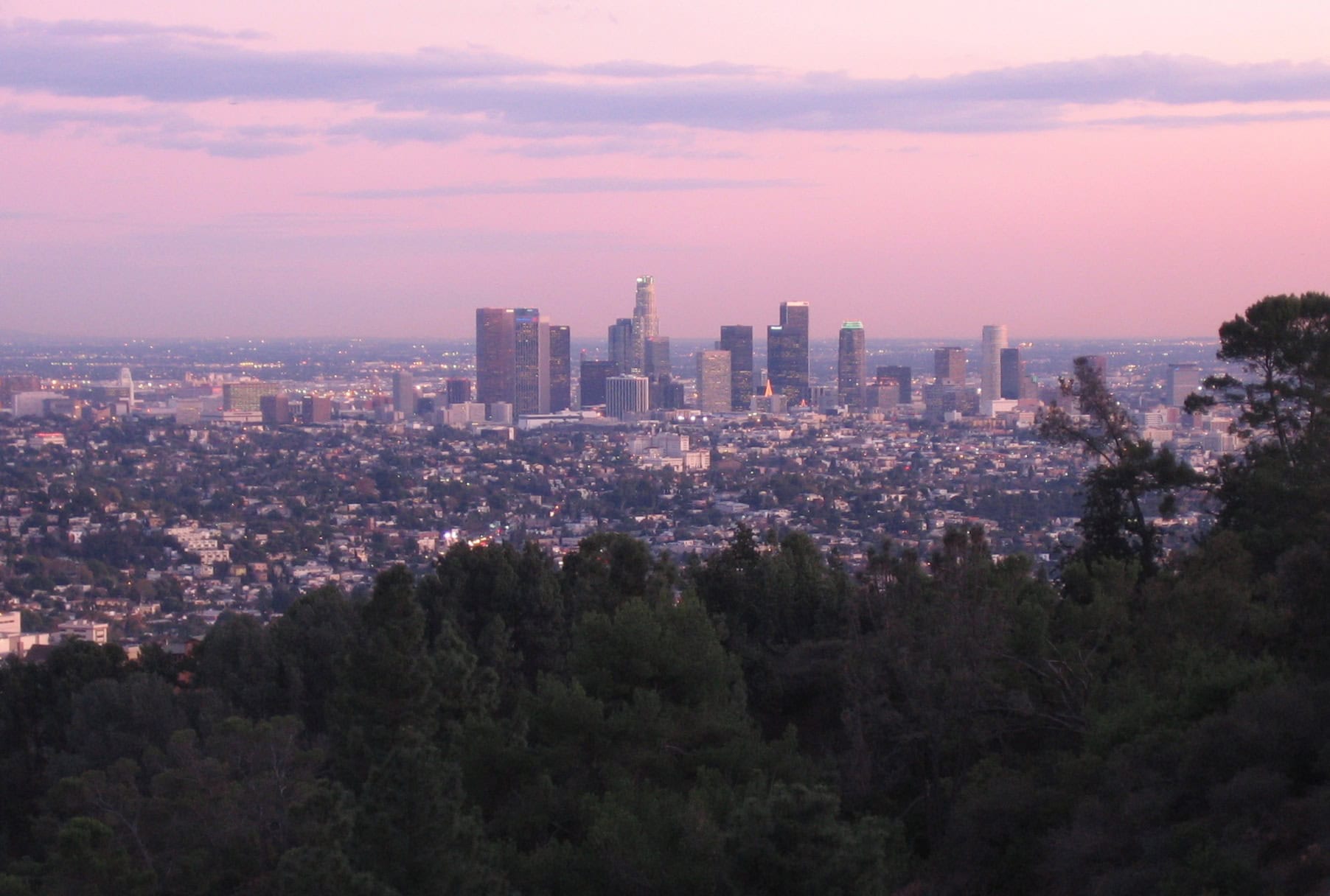 A distant view of the Los Angeles skyline with a pastel sky.