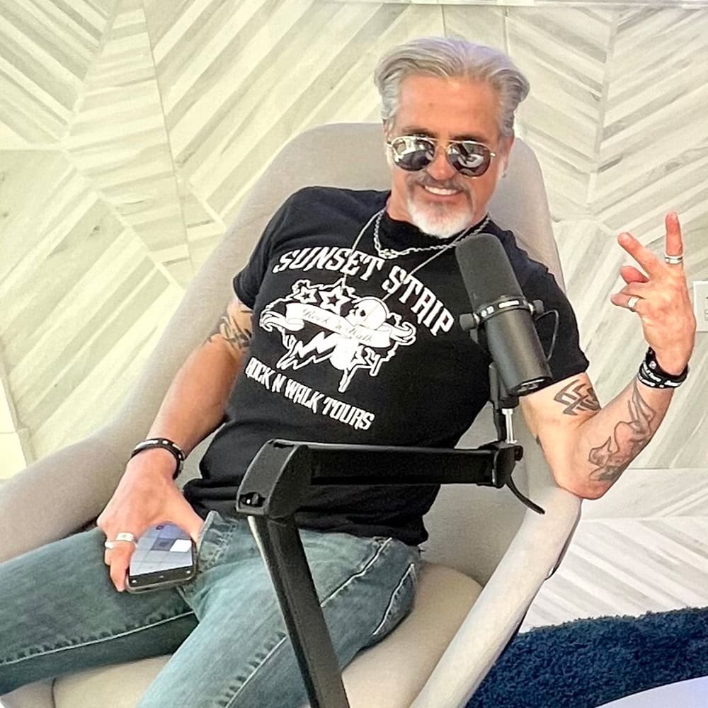 Writer and tour guide Jon D'Amico sits in a chair during a recording of The Creators Podcast