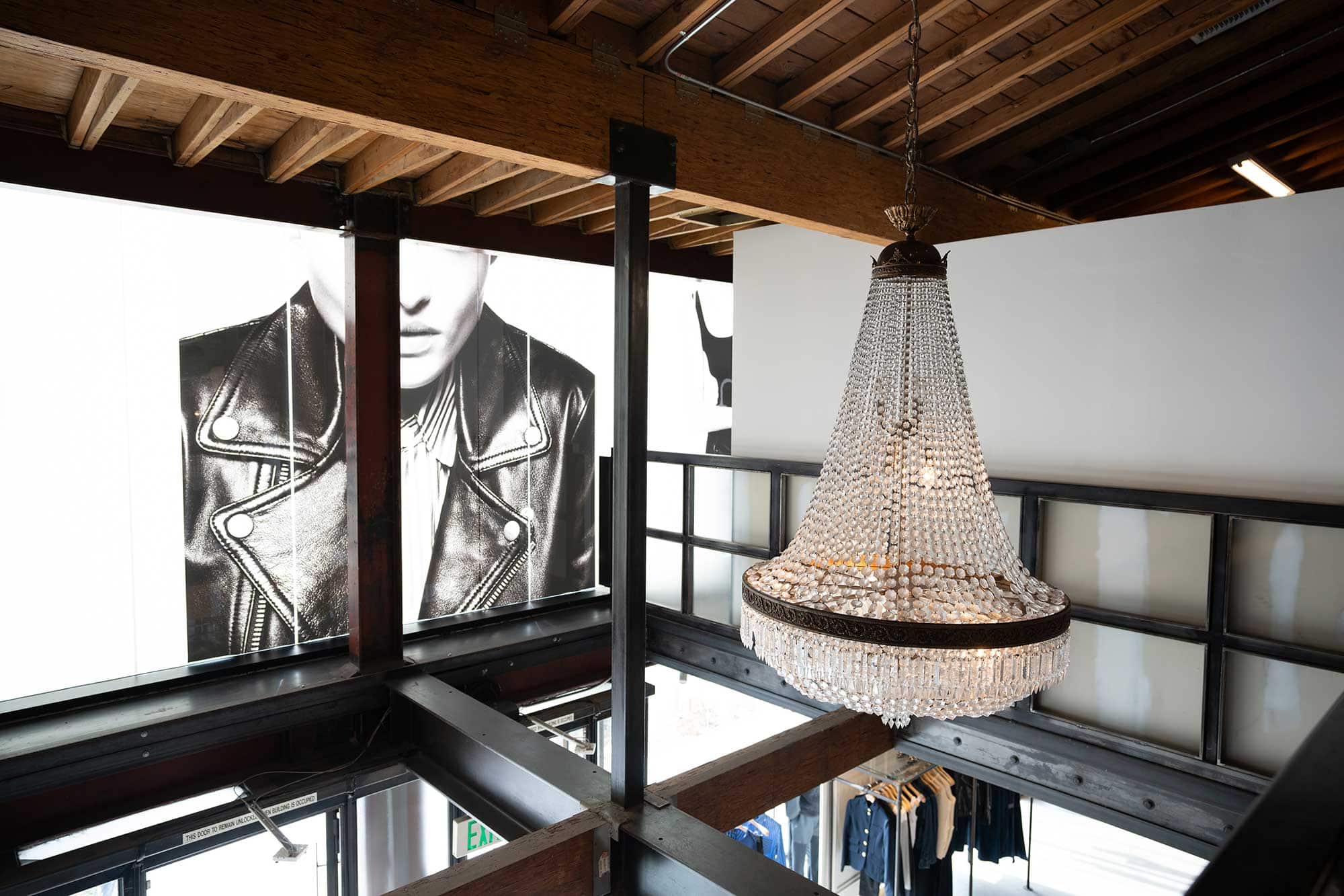 A large crystal chandelier hangs in front of an edgy black-and-white image at Rag & Bone in West Hollywood