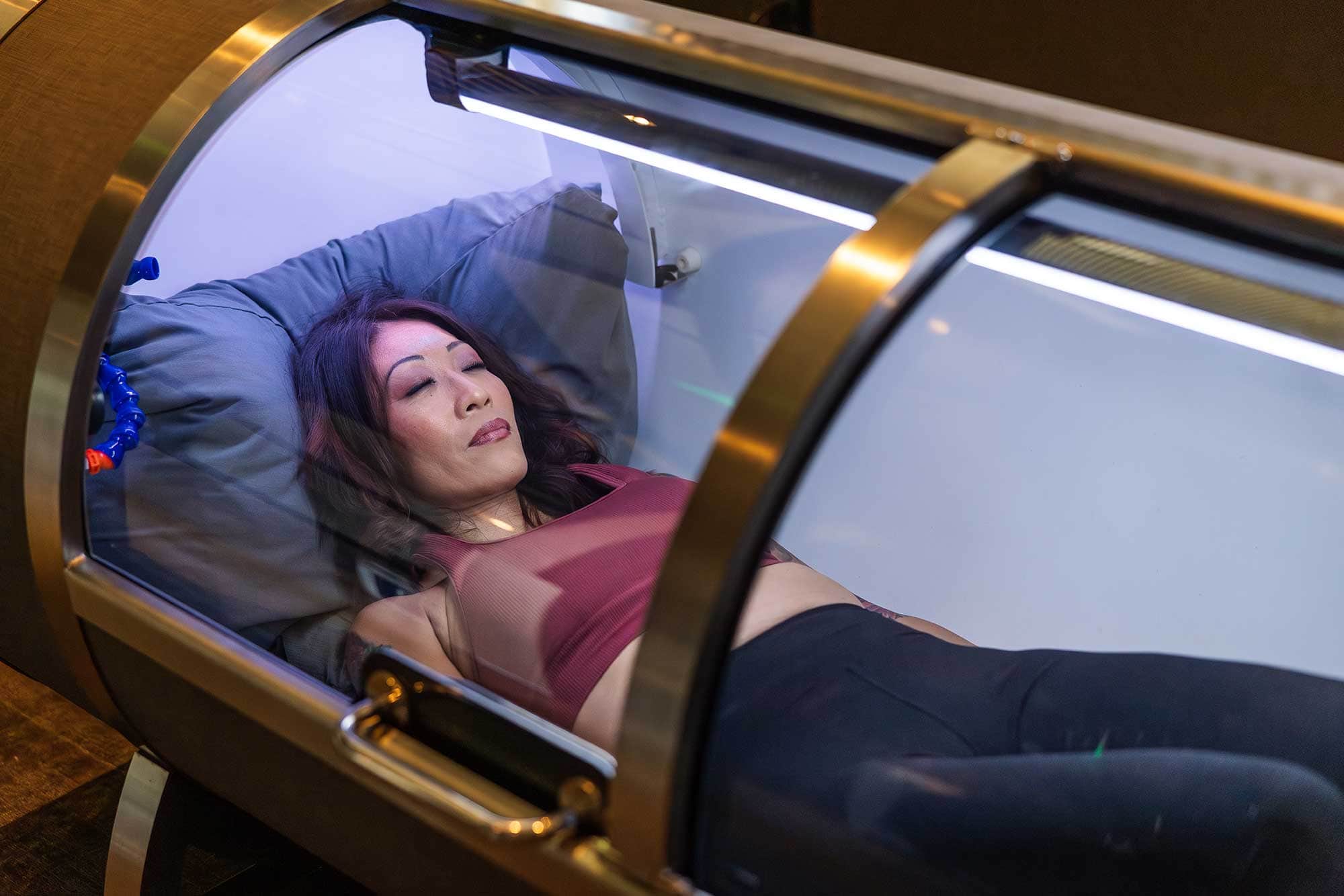 A woman lies inside a hyperbaric oxygen chamber at Remedy Place in West Hollywood.