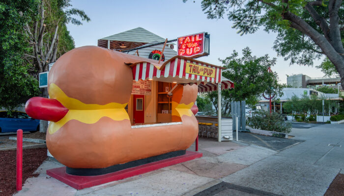 Tail O' the Pup hot dog stand is lit up at twilight