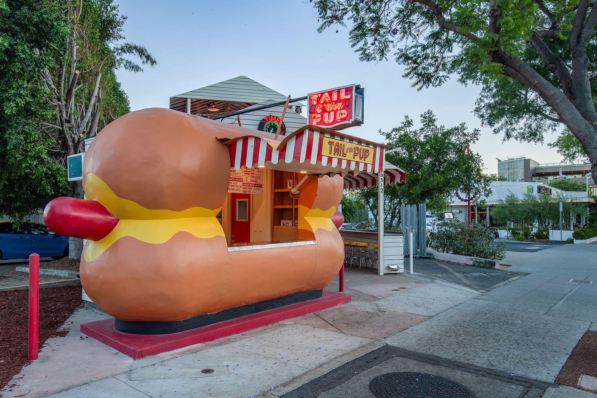 Tail O' the Pup hot dog stand is lit up at twilight