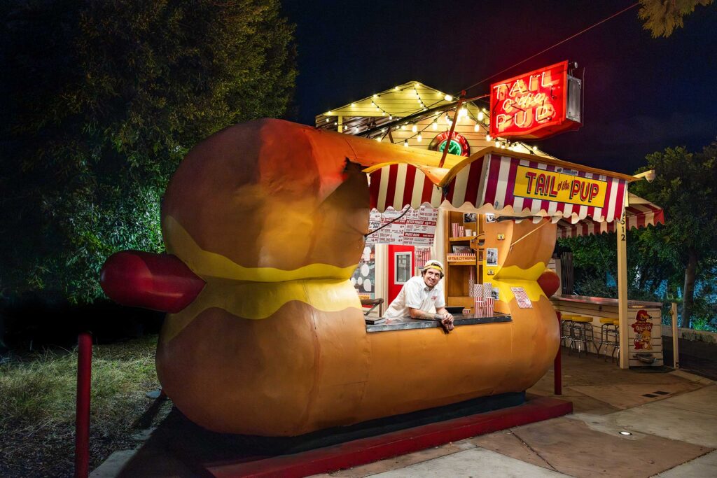 A man tends the counter at the iconic Tail O' the Pup in West Hollywood, California