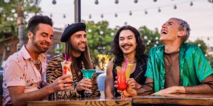 A group or four men share drinks at a nightclub in West Hollywood's Rainbow District.