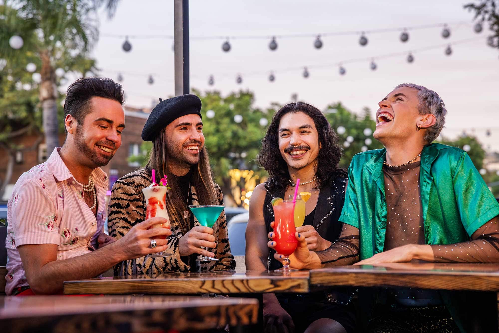 A group or four men share drinks at a nightclub in West Hollywood's Rainbow District.