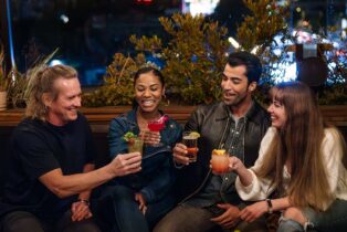A group raises glasses on a rooftop in West Hollywood