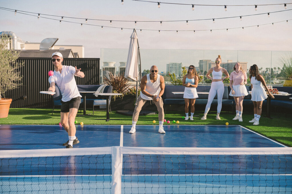 People participate in a pickleball tournament at the Kimpton La Peer Hotel