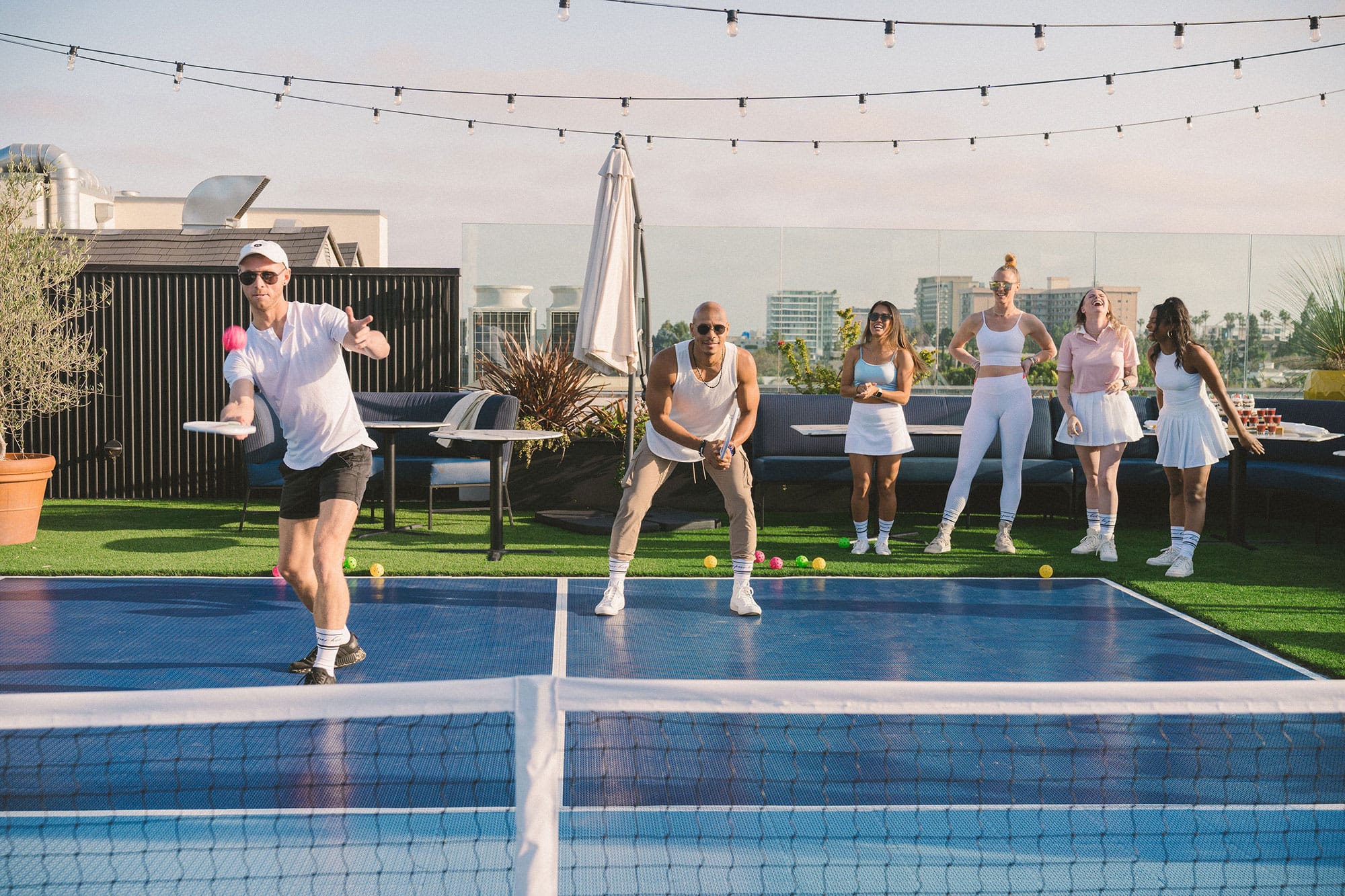 People participate in a pickleball tournament at the Kimpton La Peer Hotel